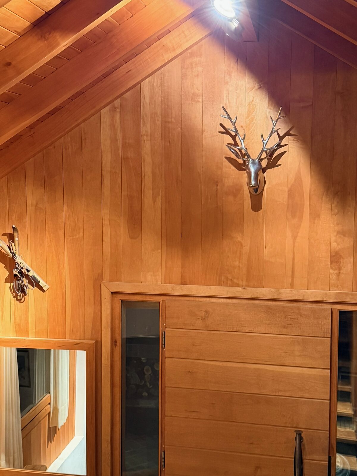 Hall frío en madera con detalles de esquíes antiguos